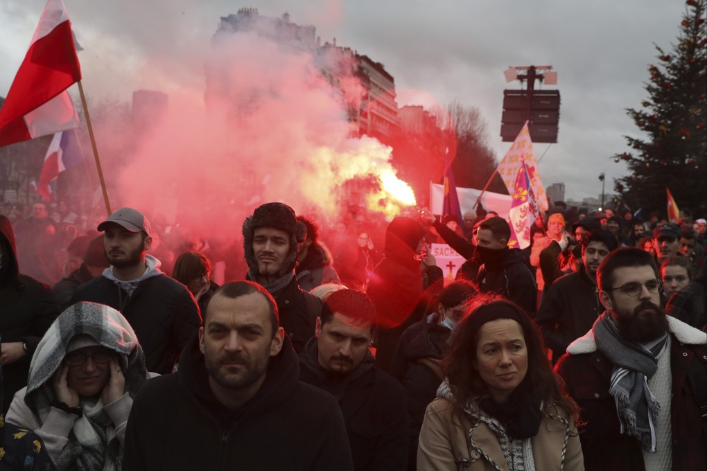 Demonstrators, in opposition to the coronavirus vaccine pass and vaccinations, gather during a rally in Paris, France on Saturday. Photo: AP
