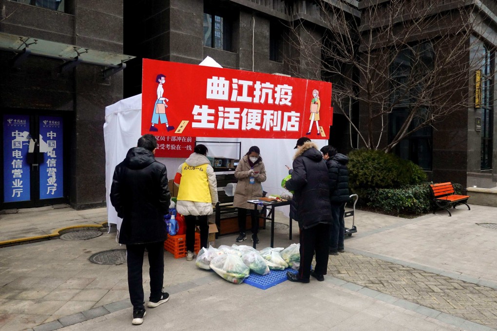 Residents buy food and daily necessities at a temporary stall set up inside a residental compound in Xian. Photo: AFP