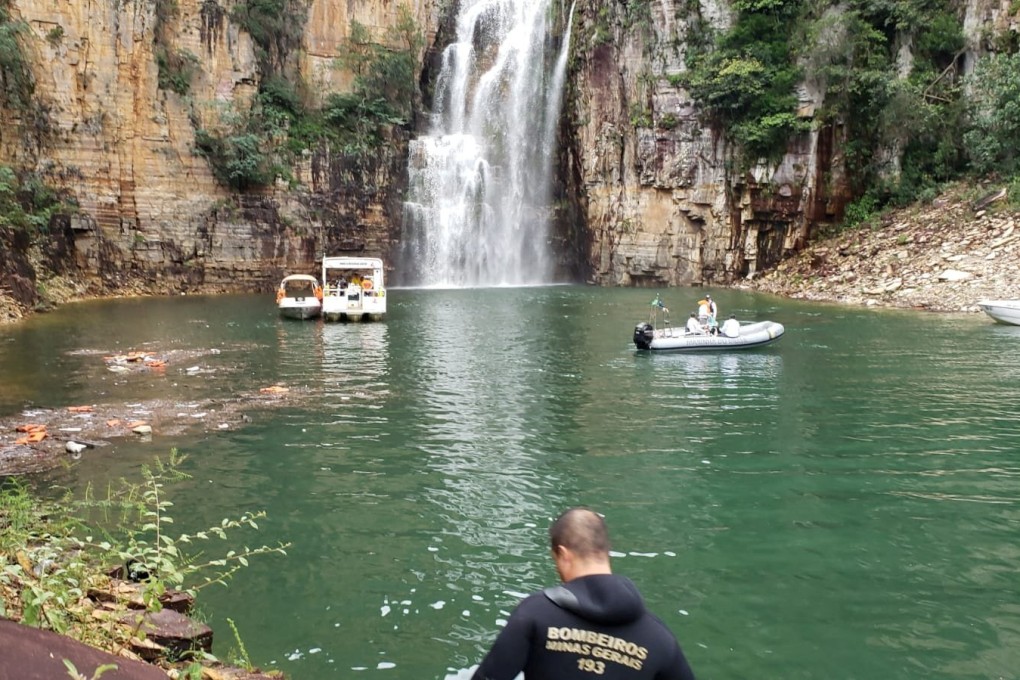 Firefighters search for victims after a wall of rock collapsed on top of motor boats below a waterfall in Minas Gerais state, Brazil. Photo: Fire brigade of Minas Gerais via Reuters