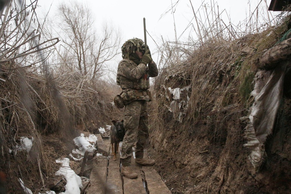 A member of the Ukrainian Territorial Defence Forces watches through spyglass in a trench on the front line with Russia-backed separatists near Avdiivka, southeastern Ukraine. Photo: AFP