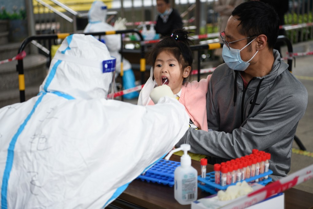 A child gets tested for Covid-19 in Shenzhen’s Futian district on Sunday. Compulsory testing is under way in the city of 12.5 million. Photo: Xinhua