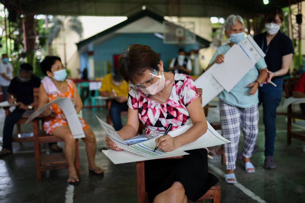 People pretend to cast their votes for the 2022 Philippine presidential election during a simulation exercise in Metro Manila last month. Photo: Reuters