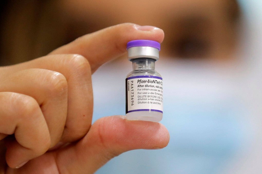 A health worker holds a vial of the Pfizer-BioNTech vaccine against Covid-19 at a vaccination centre in Santiago on Monday. Photo: AFP