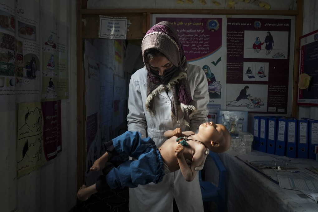A nurse checks the weight of a child in a makeshift clinic organised by World Vision at a settlement near Herat, Afghanistan. Malnutrition stalks the most vulnerable, and aid groups say more than half the population faces acute food shortages. Photo: AP