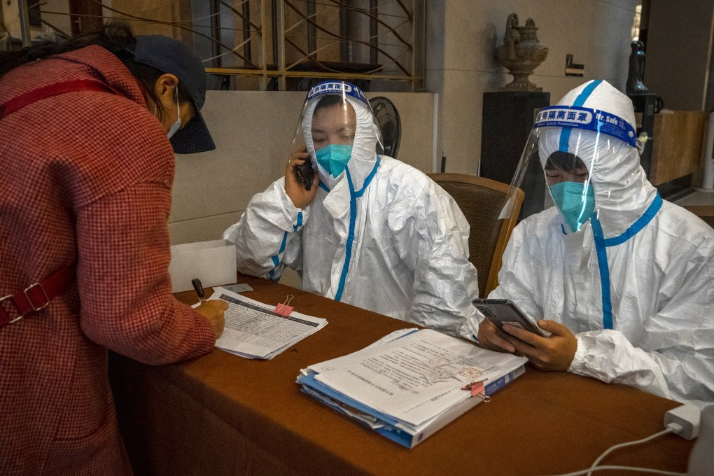 A woman checks into a hotel for quarantine in Wuhan on December 23, 2021. A US Senate bill would sanction Chinese officials who prevent an investigation into the lab-leak theory about Covid-19’s origins.  Photo: Bloomberg