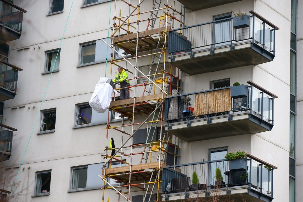 A construction worker inspects cladding at Royal Artillery Quays residential apartments in London. Photo: Bloomberg