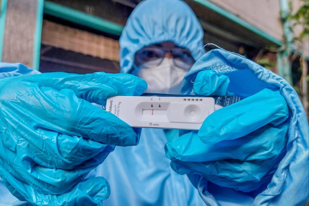 A medical worker shows a negative Covid-19 antigen test result in Quezon City, the Philippines, on Monday. Photo: Xinhua