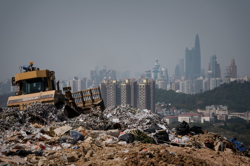 This picture taken on March 6, 2013 shows a landfill in the new territories of Hong Kong as the Chinese city of Shenzhen looms in the background.  Official data shows that the city generates about 19,000 tonnes of solid waste every day, with 9,100 tonnes dumped into landfills -- two thirds of it domestic waste. Only 52 percent of total waste is recycled in a city that produces an average of 921 kilograms of rubbish per person per year, which is more than twice the amount compared to Japan (410kg) and South Korea (380kg), according to the Organisation for Economic Cooperation and Development.  AFP PHOTO / Philippe Lopez (Photo by Philippe LOPEZ / AFP)
