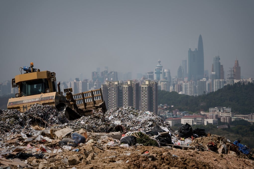This picture taken on March 6, 2013 shows a landfill in the new territories of Hong Kong as the Chinese city of Shenzhen looms in the background. Official data shows that the city generates about 19,000 tonnes of solid waste every day, with 9,100 tonnes dumped into landfills -- two thirds of it domestic waste. Only 52 percent of total waste is recycled in a city that produces an average of 921 kilograms of rubbish per person per year, which is more than twice the amount compared to Japan (410kg) and South Korea (380kg), according to the Organisation for Economic Cooperation and Development. AFP PHOTO / Philippe Lopez (Photo by Philippe LOPEZ / AFP)