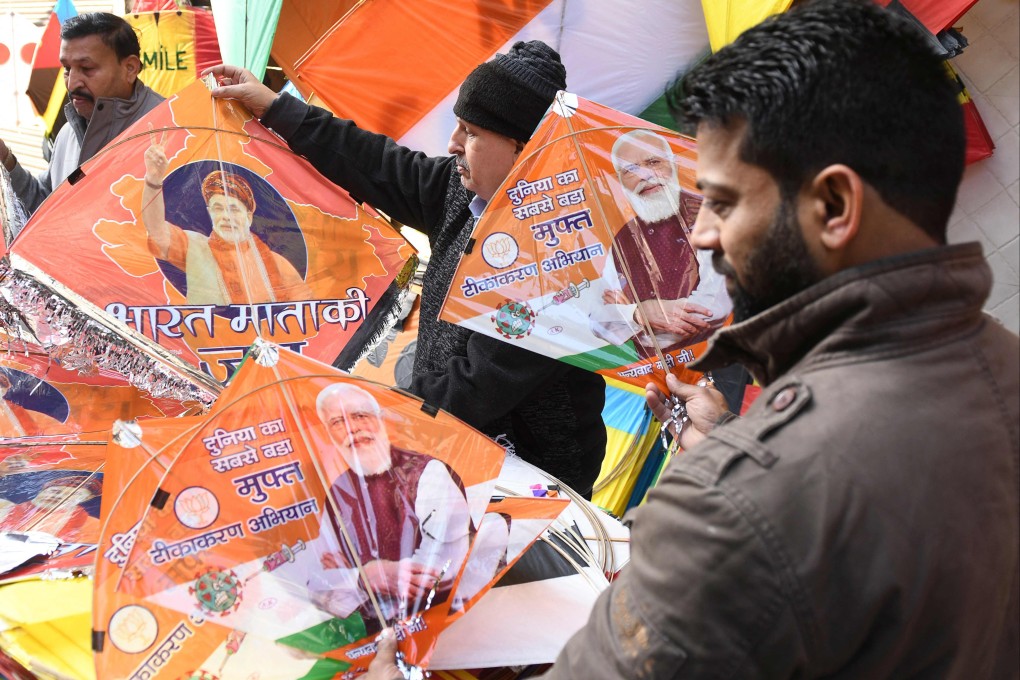 People buy kites bearing the image of India’s Prime Minister Narendra Modi. Photo: AFP