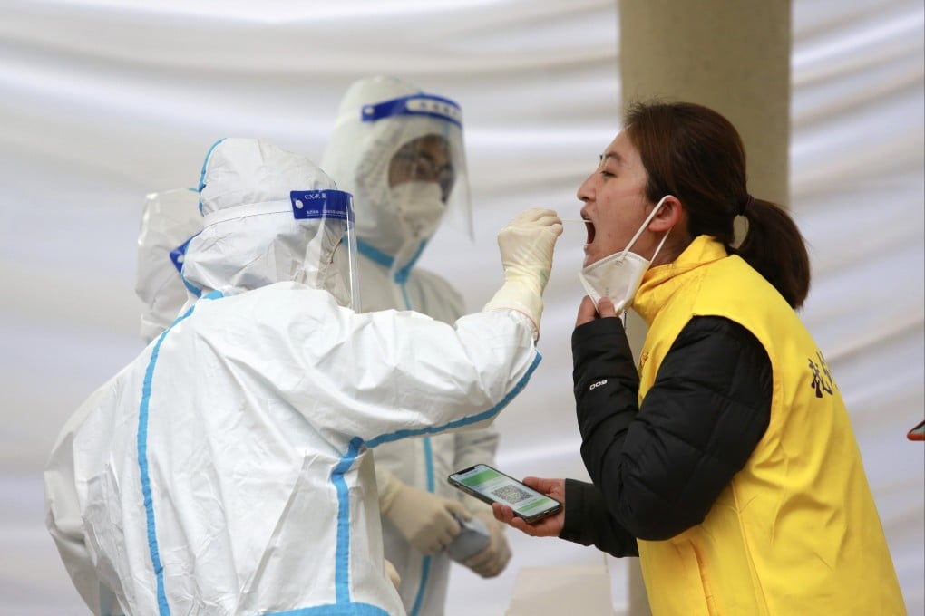 Workers take a sample from a woman for a Covid-19 test in Xi’an, northwestern China. Photo: AP