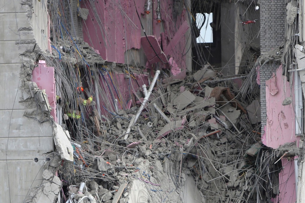 A rescuer searches through debris for workers who went missing in an apartment construction accident in Gwangju, South Korea, on Thursday. Photo: Yonhap via AP