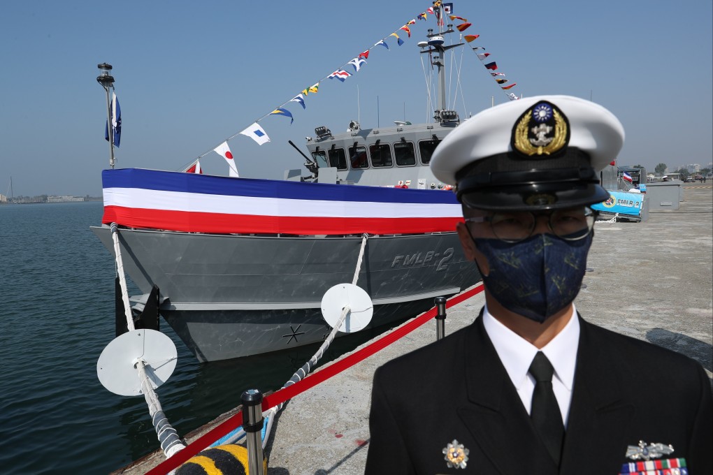 A Taiwan navy officer stands guard in front of a domestically produced mine-laying ship during an inauguration ceremony at a naval base in Kaohsiung, Taiwan, on Friday. Photo: EPA-EFE