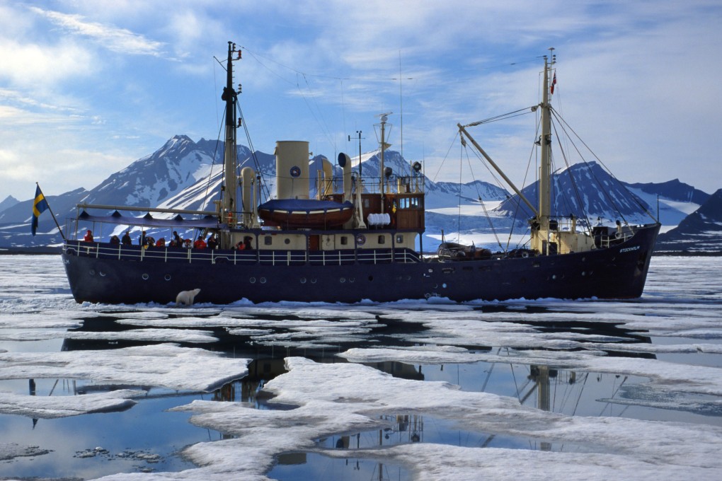 A curious polar bear checks out a ship in icy waters off the coast of Svalbard, a Norwegian archipelago between Norway and the North Pole. Photo: Universal Images Group via Getty Images
