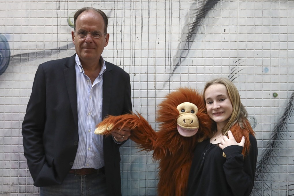 EcoMatcher CEO Bas Fransen (left) with 13-year-old Elodie Lambotte and her orangutan puppet Jack. The teen is calling on companies to protect the environment. Photo: Jonathan Wong