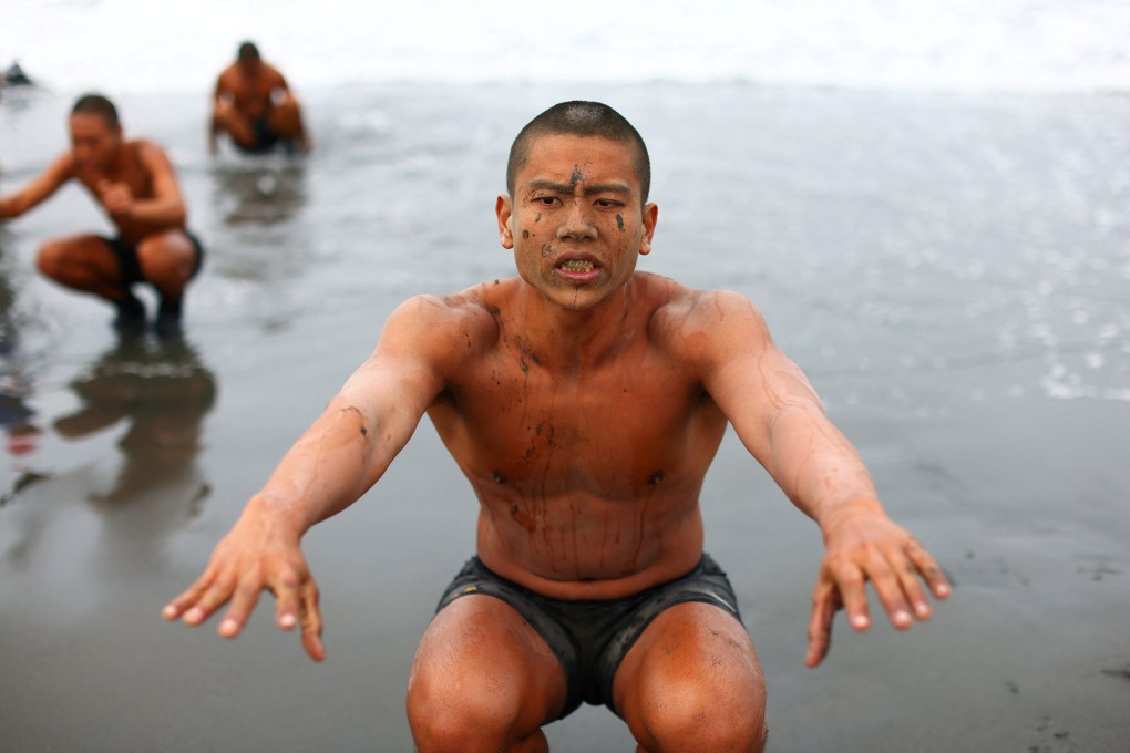 Wang Zheng-Jun holds a squat during the last week of a 10-week programme to become a member of the Taiwan navy’s elite Amphibious Reconnaissance and Patrol unit, at Zuoying navy base, Kaohsiung, in southern Taiwan. Photo: Reuters