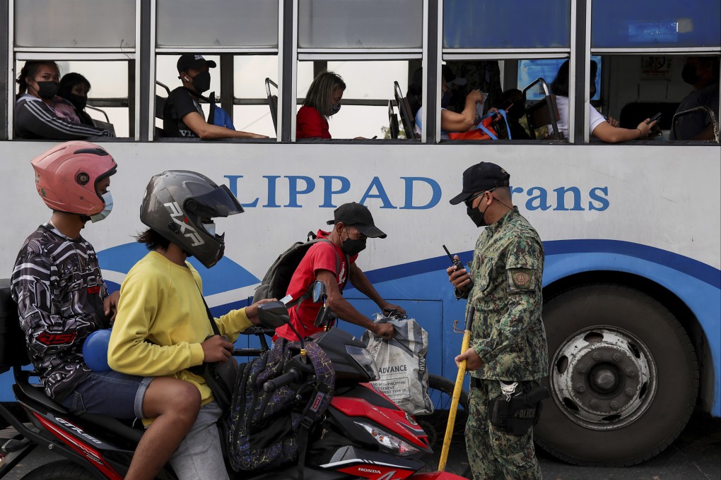 A police officer checks documents at a Covid-19 checkpoint. Photo: AP