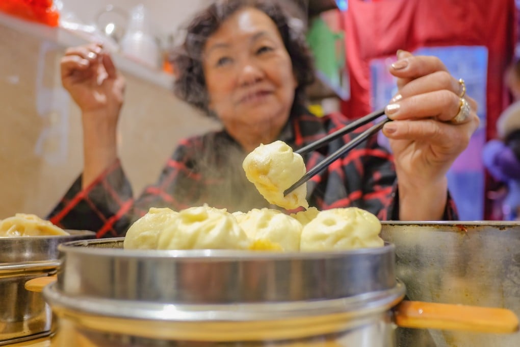 An elderly Chinese woman enjoys a traditional dim sum meal. The threat of losing out on such meals finally convinced many elderly Hong Kong residents to get vaccinated against Covid-19. Photo: Getty Images