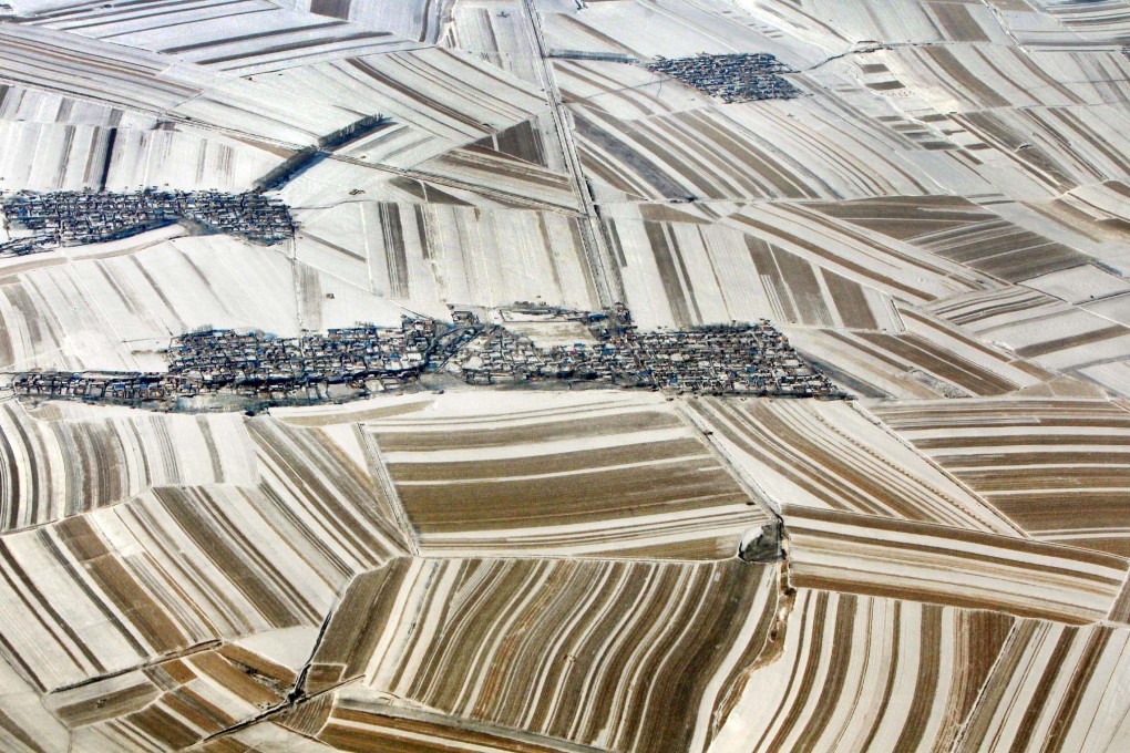 An aerial view of the snow-covered frozen fields and village houses in northeast China’s Heilongjiang province on Feb. 26, 2012. Photo: CNS