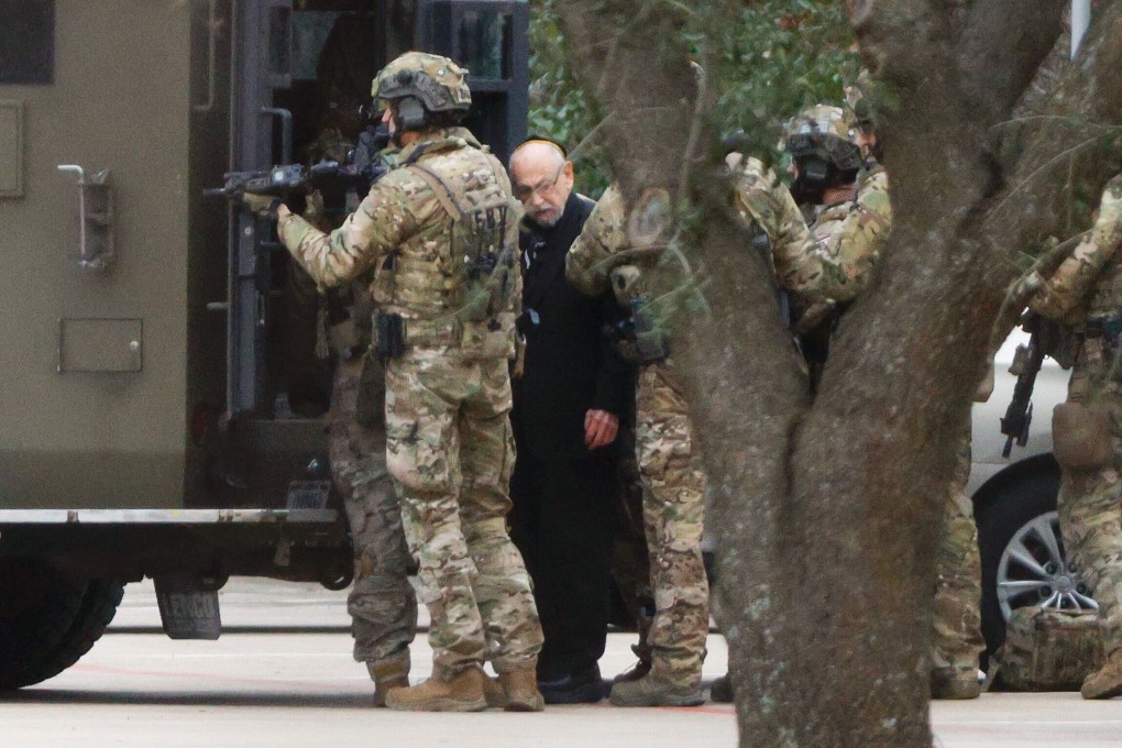 Authorities escort one of the hostages out of the Congregation Beth Israel synagogue in Colleyville, Texas. Photo: AP