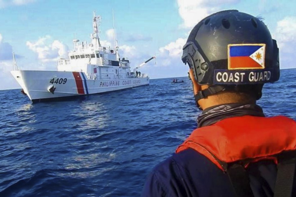 Members of the Philippine Coast Guard patrol Whitsun Reef in the South China Sea, much of which is claimed by Beijing. Photo: Philippine Coast Guard via AP