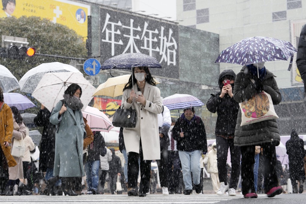 People at a busy intersection in Tokyo. Photo: AP