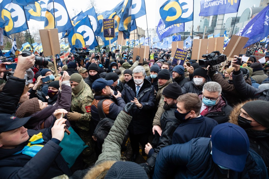 Supporters greet former Ukrainian President Petro Poroshenko near the Pechersky district court. Photo: Handout via EPA-EFE