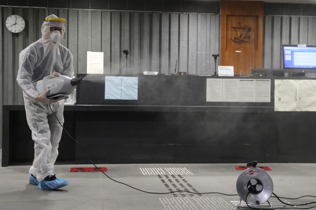 A specialist disinfects the reception area of the Legco complex on January 6, after officials and lawmakers were found to have attended the same birthday party as a person who tested positive for Covid-19. Photo: May Tse