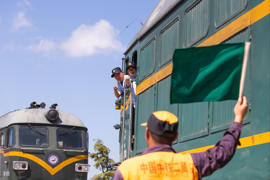 A Lao trainee learns signals from her Chinese mentor ahead of the opening of the Boten-Vientiane high-speed rail. Photo: Xinhau