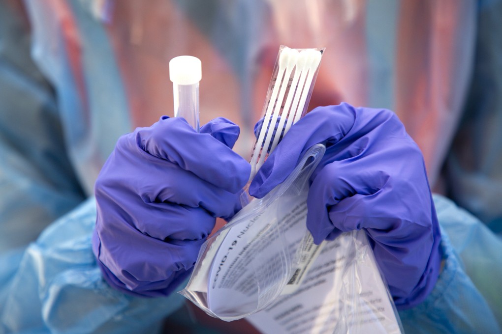 A nurse shows components of a free drive-through Covid-19 testing kit available for at-risk people in Raleigh, North Carolina, in June 2020. Photo: TNS