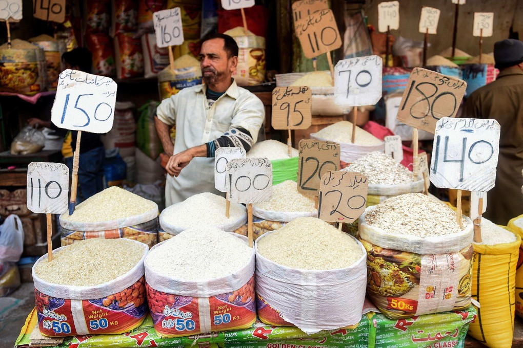 A shopkeeper waits for customers at a market in Karachi, Pakistan. Photo: AFP