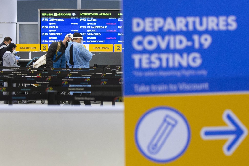 A medical worker talks to a traveller at a Covid-19 testing site in Toronto’s international airport on Monday.  Photo: Xinhua