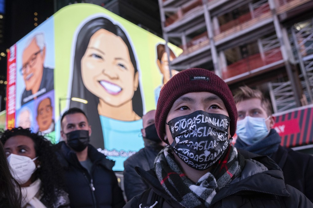 A person wearing a face mask reading “Stop Asian Hate” attends a candlelight vigil in honour of Michelle Alyssa Go in New York on Tuesday. Photo: AP