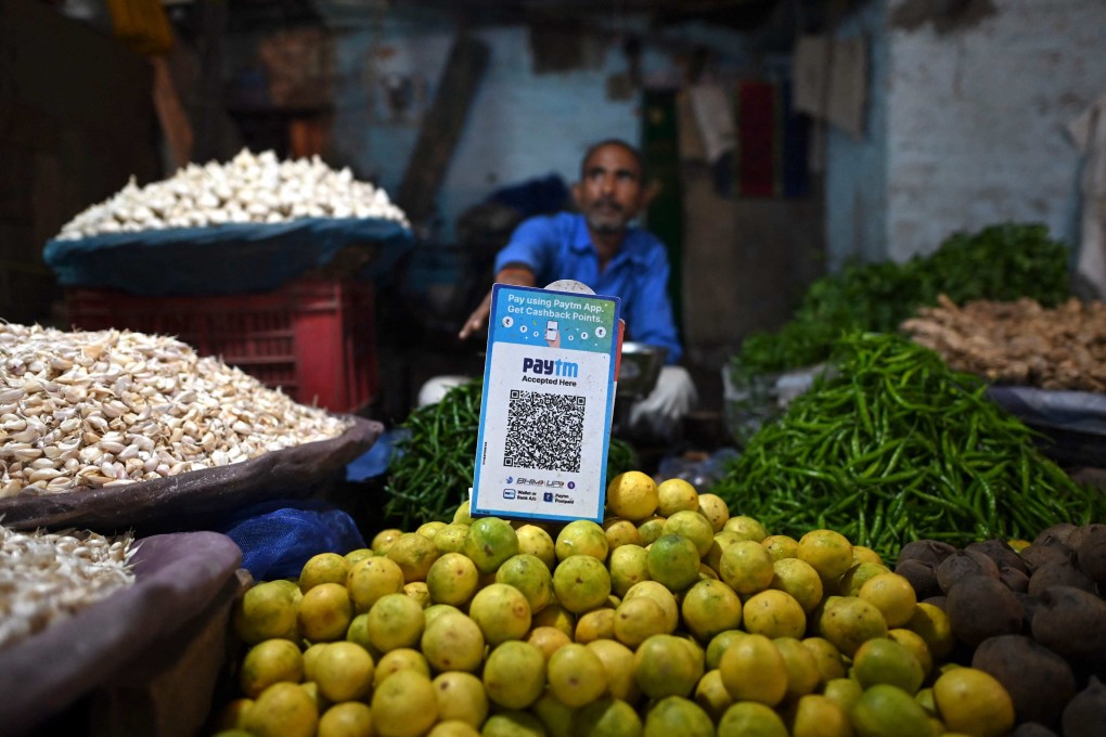 A vegetable seller displays a barcode for Paytm, an Indian cellphone-based digital payment platform, as he waits for customers at a market in New Delhi on November 8, 2021. Photo: AFP
