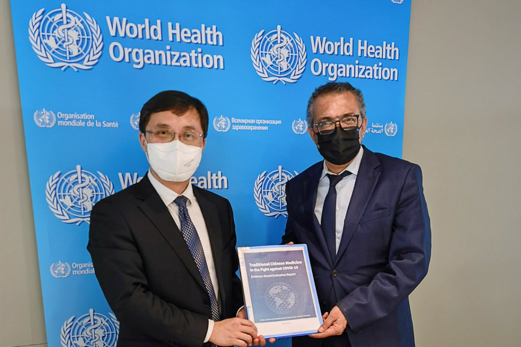 Huang Luqi, a vice-commissioner of the National Administration of Traditional Chinese Medicine, presents the report to WHO chief Tedros Adhanom Ghebreyesus. Photo: Handout