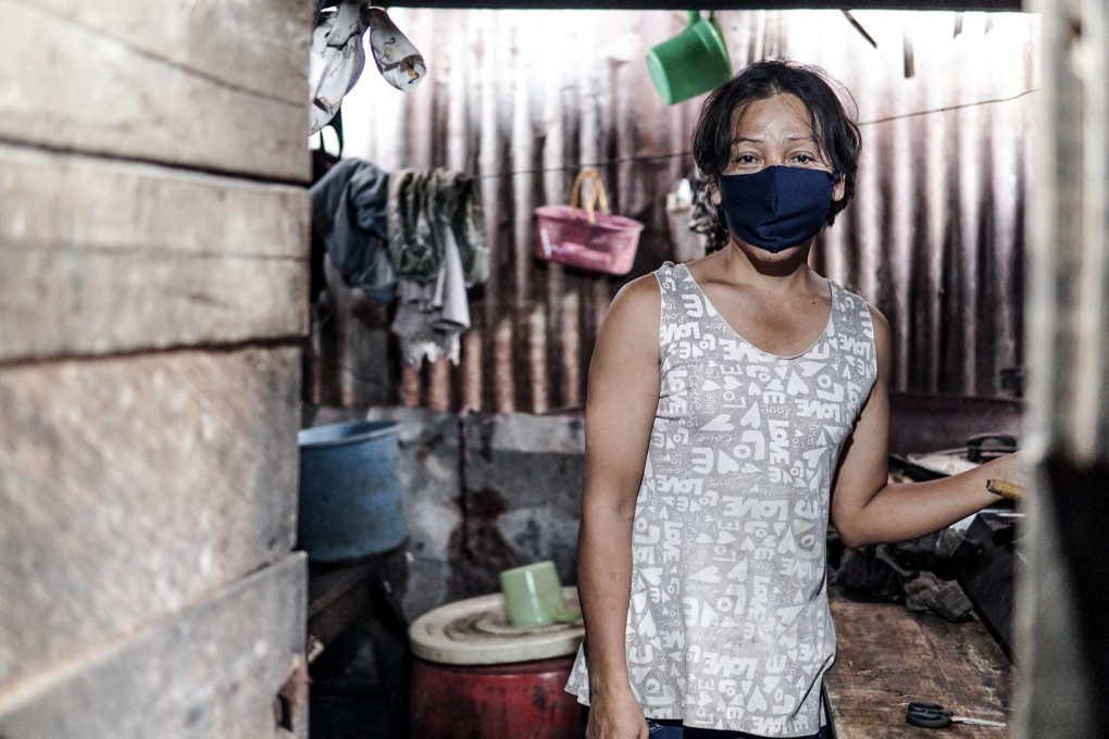 Merry in the wooden shack she used to rent. Photo: Navid Alhusna