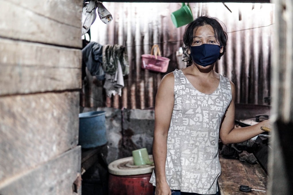 Merry in the wooden shack she used to rent. Photo: Navid Alhusna
