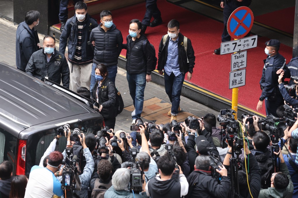 National security police escort Stand News acting editor-in-chief Patrick Lam from the outlet’s Kwun Tong office in December 2021. Photo: May Tse