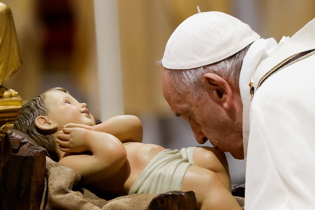 Pope Francis kisses a statue of baby Jesus as he celebrates Christmas Eve Holy Mass in St Peter’s Basilica at the Vatican on December 24, 2021. St Joseph, the earthly father of Jesus, was the subject of one of the Pope’s recent addresses. Photo: Reuters
