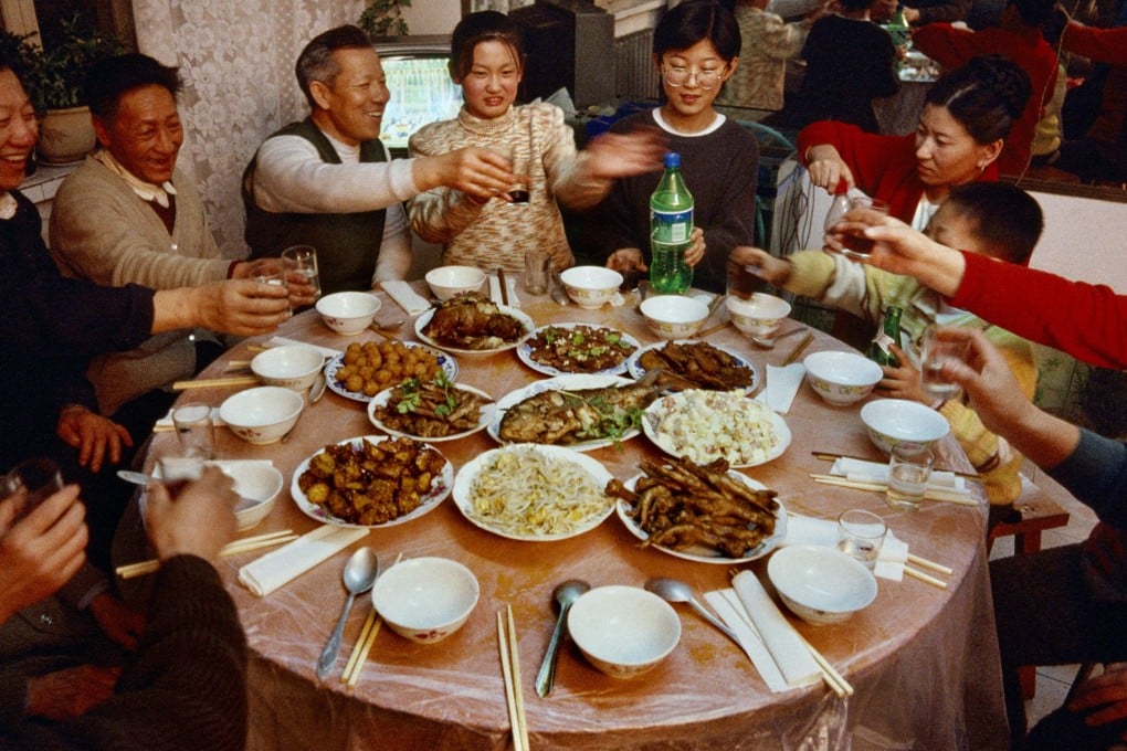 A family celebrate the Lunar New Year in Heihe, China, in 1999. Recipes for dishes for festivals like this are recreated in Chinese Feasts & Festivals – A Cookbook. Photo: Getty Images