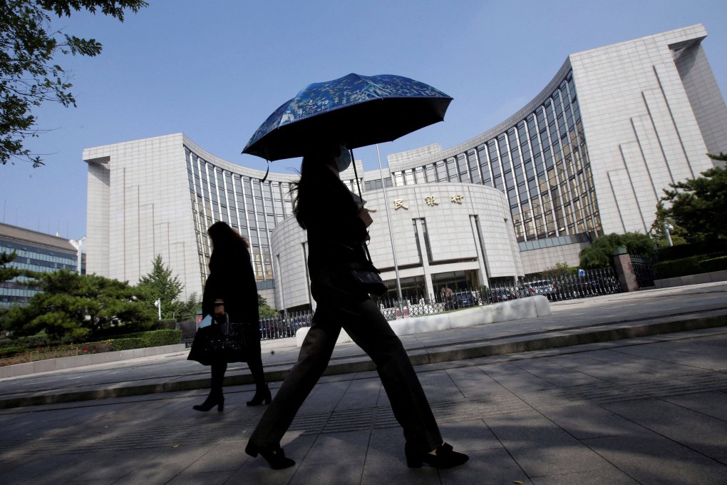 People walk past the headquarters of the People’s Bank of China in Beijing. Photo: Reuters