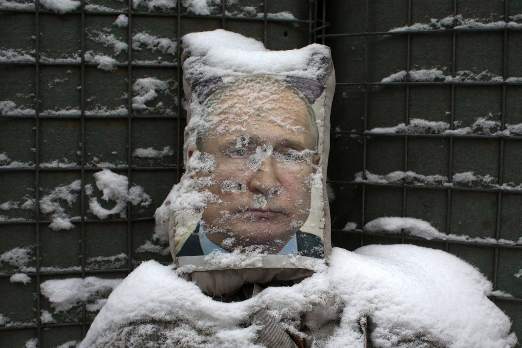 A poster of Russian President Vladimir Putin, used as target practice by Ukrainian troops. Photo: AFP