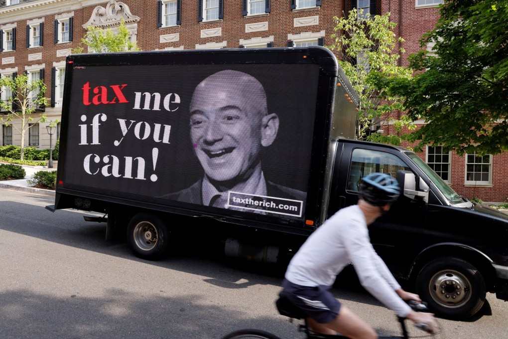 A protest video on a lorry paid for by the “Patriotic Millionaires” group drives past a mansion owned by Amazon founder Jeff Bezos in Washington, DC, on May 17, 2021. The group is calling for higher tax rates for the super-rich to address rising inequality. Photo: Reuters
