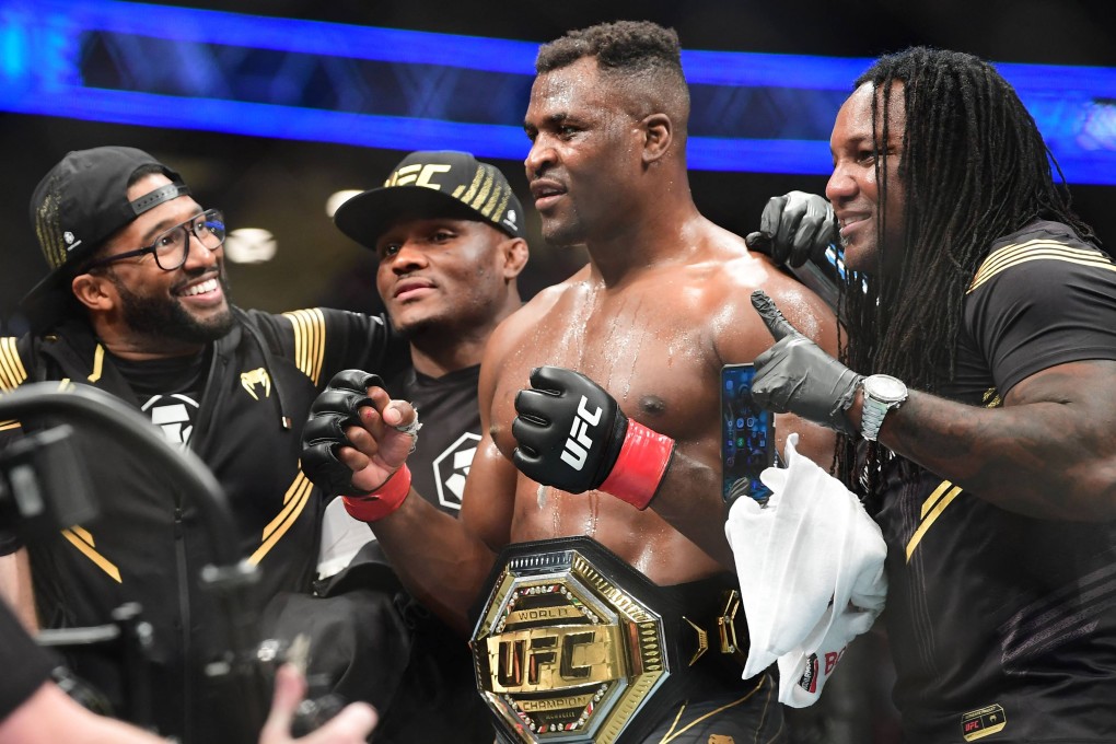 UFC 270 heavyweight world champion Cameroon’s Francis Ngannou (C) celebrates victory over France’s Ciryl Gane after their fight for the heavyweight title at the Honda Center in Anaheim, California on January 22, 2022. (Photo by Frederic J. BROWN / AFP)