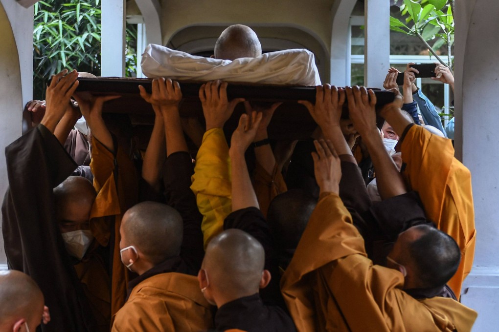 Buddhist monks carry the body of Thich Nhat Hanh during his funeral ceremony at the Tu Hieu Pagoda in Hue, Vietnam. Photo: AFP