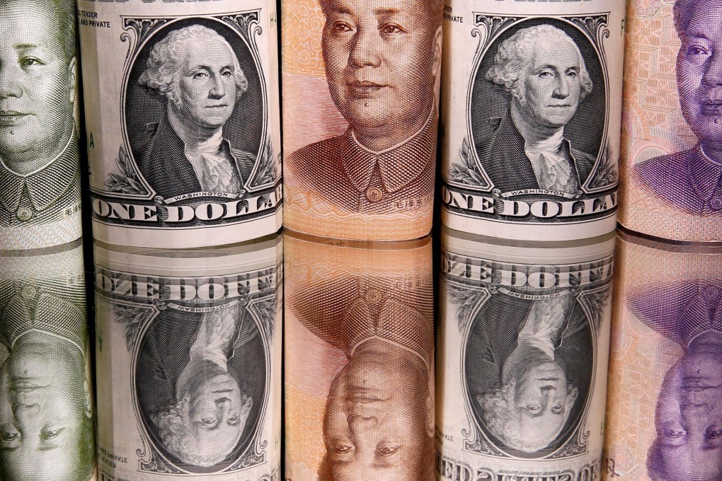 Chinese renminbi and US dollar banknotes are seen in February 2020. With the China-US trade balance heavily skewed in Beijing’s favour, the demand for renminbi will remain strong. Photo: Reuters