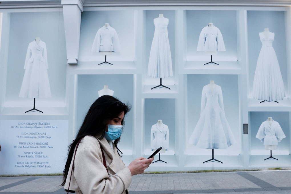 A woman wearing a protective face mask walks on the Champs Elysees in Paris. Photo: Reuters