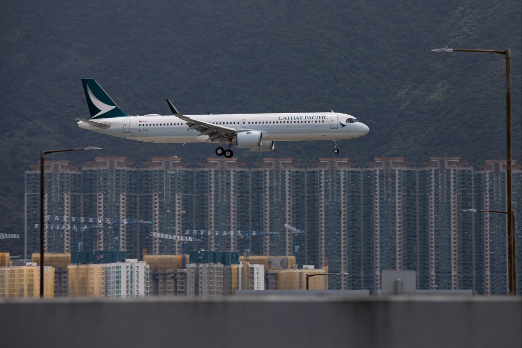 A Cathay Pacific jet prepares to land at Hong Kong International Airport. The airline is expect to post a smaller loss for 2021. Photo: EPA-EFE