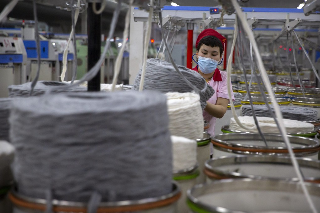 A worker gathers cotton yarn at a textile manufacturing plant in the Xinjiang region of China, where human rights abuses are suspected. Photo: AP