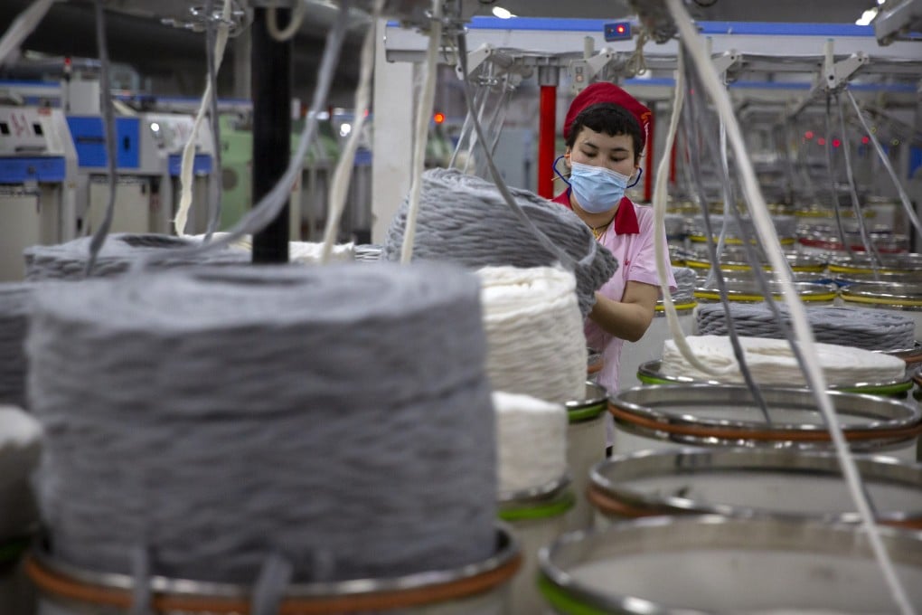 A worker gathers cotton yarn at a textile manufacturing plant in the Xinjiang region of China, where human rights abuses are suspected. Photo: AP